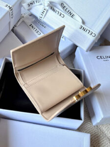 Small Flap Wallet Triomphe. Authentic quality luxury bag crafted in genuine leather comes with authenticity card, dust bag and gift bag. Small in Size, Grand in Style. Discover timeless sophistication in the palm of your hand with the *ELINE Small Flap Wallet TRIOMPHE in shiny calfskin. Meticulously crafted from luxurious leather, this compact beauty showcases the iconic Triomphe clasp in gold-tone metal, a refined nod to Parisian heritage. Despite its petite size, it opens to reveal smart compartments for cards, bills, and coins—proving that style never compromises function. Whether tucked into your favorite designer bag or carried solo for a night out, this wallet is your everyday dose of quiet luxury. - CRIS&COCO Small Flap Wallet Triomphe. Authentic quality luxury bag crafted in genuine leather comes with authenticity card, dust bag and gift bag. Small in Size, Grand in Style. Discover timeless sophistication in the palm of your hand with the *ELINE Small Flap Wallet TRIOMPHE in shiny calfskin. Meticulously crafted from luxurious leather, this compact beauty showcases the iconic Triomphe clasp in gold-tone metal, a refined nod to Parisian heritage. Despite its petite size, it opens to reveal smart compartments for cards, bills, and coins—proving that style never compromises function. Whether tucked into your favorite designer bag or carried solo for a night out, this wallet is your everyday dose of quiet luxury.