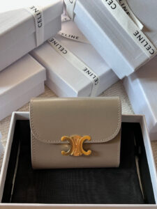 Small Flap Wallet Triomphe. Authentic quality luxury bag crafted in genuine leather comes with authenticity card, dust bag and gift bag. Small in Size, Grand in Style. Discover timeless sophistication in the palm of your hand with the *ELINE Small Flap Wallet TRIOMPHE in shiny calfskin. Meticulously crafted from luxurious leather, this compact beauty showcases the iconic Triomphe clasp in gold-tone metal, a refined nod to Parisian heritage. Despite its petite size, it opens to reveal smart compartments for cards, bills, and coins—proving that style never compromises function. Whether tucked into your favorite designer bag or carried solo for a night out, this wallet is your everyday dose of quiet luxury. - CRIS&COCO Small Flap Wallet Triomphe. Authentic quality luxury bag crafted in genuine leather comes with authenticity card, dust bag and gift bag. Small in Size, Grand in Style. Discover timeless sophistication in the palm of your hand with the *ELINE Small Flap Wallet TRIOMPHE in shiny calfskin. Meticulously crafted from luxurious leather, this compact beauty showcases the iconic Triomphe clasp in gold-tone metal, a refined nod to Parisian heritage. Despite its petite size, it opens to reveal smart compartments for cards, bills, and coins—proving that style never compromises function. Whether tucked into your favorite designer bag or carried solo for a night out, this wallet is your everyday dose of quiet luxury.