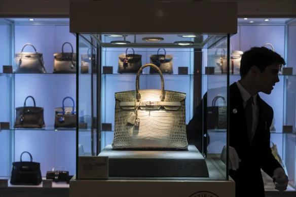 A rare crocodile Birkin takes center stage in a display of elusive luxury. A rare crocodile Birkin takes center stage in a display of elusive luxury.