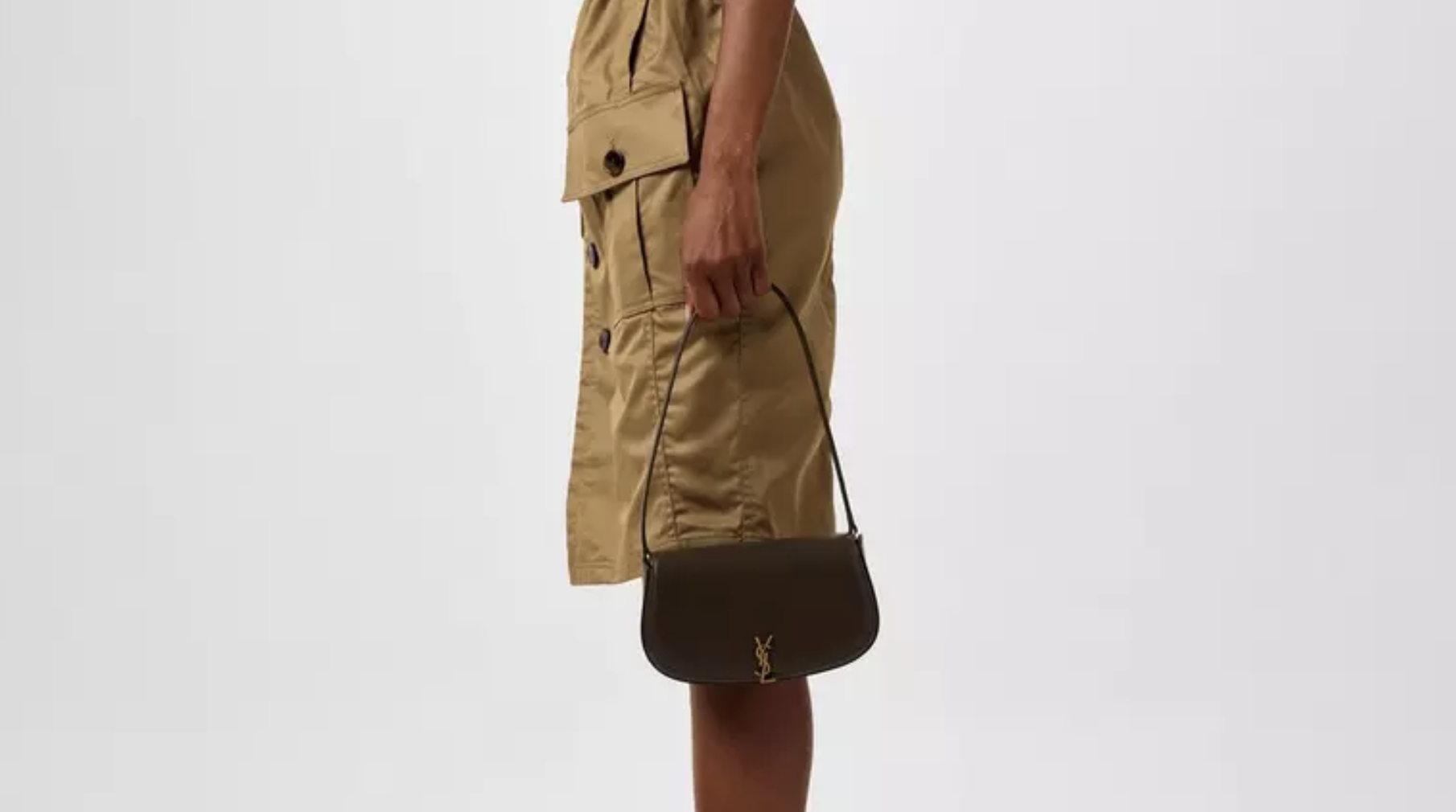 Soft pink HERMES Kelly bag in a flower-filled spring setting Pastel HERMES Kelly bag on a spring background