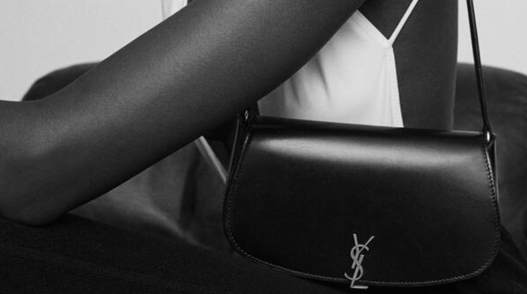 SAINT LAURENT Loulou bag with autumn leaves SAINT LAURENT Loulou bag in brown leather surrounded by autumn leaves