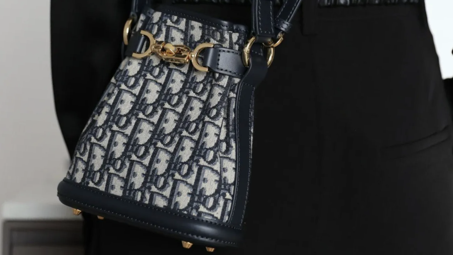 Dior C’est Bag in the signature navy Dior Oblique canvas with leather trim and gold clasp. Dior C’est Bag in the signature navy Dior Oblique canvas with leather trim and gold clasp.