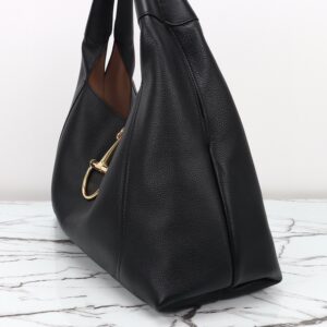 Softbit Maxi Shoulder Bag. Authentic quality luxury bag crafted in genuine leather comes with authenticity card, dust bag and gift bag. Icon Reimagined: Effortless Luxury with a Modern Bit of Bold. *ucci’s timeless heritage meets contemporary ease in the new Softbit Shoulder Bag. Crafted from supple grained leather with a luxuriously rich texture, this piece balances sophistication and function effortlessly. At its heart lies an oversized half-horsebit — a bold reinterpretation of the House’s iconic detail — accenting the magnetic closure with statement appeal. With its relaxed silhouette and refined craftsmanship, the Softbit is the perfect companion for those who favor effortless elegance with a modern edge.