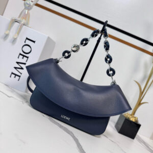 Medium Ola Bag. Authentic quality luxury bag crafted in genuine leather comes with authenticity card, dust bag and gift bag. Soft Curves, Bold Style. Introducing the *OEWE Ola Bag — Where Fluid Design Meets Effortless Luxury. This Ola bag is your new summer essential: soft, lightweight, and irresistibly modern. Defined by its beautifully curved silhouette, flowing flap, and iconic donut chain detail, this piece blends sculptural elegance with everyday practicality. Crafted in smooth, premium calfskin, the medium Ola offers a refined touch while remaining exceptionally versatile. Whether worn for daytime ease or evening polish, it elevates any look with its understated yet striking aesthetic. A statement of craftsmanship. A celebration of movement. A summer icon in the making.