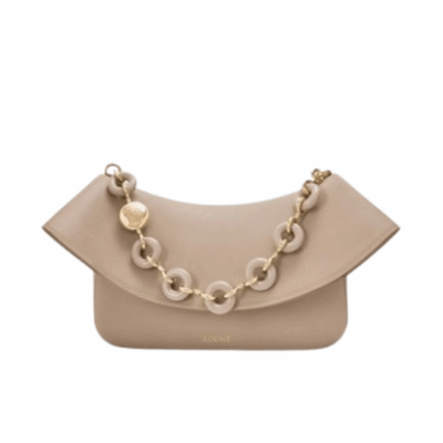 Medium Ola Bag. Authentic quality luxury bag crafted in genuine leather comes with authenticity card, dust bag and gift bag. Soft Curves, Bold Style. Introducing the *OEWE Ola Bag — Where Fluid Design Meets Effortless Luxury. This Ola bag is your new summer essential: soft, lightweight, and irresistibly modern. Defined by its beautifully curved silhouette, flowing flap, and iconic donut chain detail, this piece blends sculptural elegance with everyday practicality. Crafted in smooth, premium calfskin, the medium Ola offers a refined touch while remaining exceptionally versatile. Whether worn for daytime ease or evening polish, it elevates any look with its understated yet striking aesthetic. A statement of craftsmanship. A celebration of movement. A summer icon in the making.