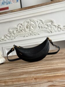 Banana Cross-Body Bag.  Authentic quality luxury bag crafted in genuine leather comes with authenticity card, dust bag and gift bag. Playful Design, Iconic Craftsmanship Meet your new style statement: the *LOÉ Banana, a charming cross-body bag crafted from luxurious shiny grained calfskin. Inspired by *loé’s legendary Spring 2001 collection, its sculptural, banana-shaped silhouette highlights the Maison’s signature artistry with a refined 3D textured effect. Perfectly sized to hold your phone, cardholder, and daily essentials, this lighthearted yet sophisticated accessory blends practicality with Parisian elegance. An adjustable strap allows effortless shoulder or crossbody wear, making it your go-anywhere companion.