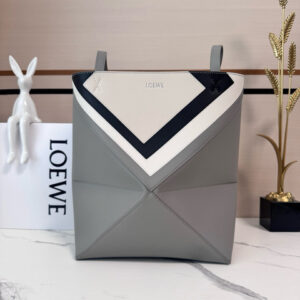 Medium Puzzle Fold Tote. Authentic quality luxury bag crafted in genuine leather comes with authenticity card, dust bag and gift bag. Modern art meets effortless luxury. This exceptional piece reimagines the iconic Puzzle Fold silhouette with a lightweight geometric structure that folds completely flat, making it the ultimate travel companion. Crafted in supple nappa calfskin, the tote features exquisite leather marquetry squares inspired by Josef Albers’s celebrated Homage to the Square series. Each panel reflects precision, balance, and *OEWE’s unmatched craftsmanship, transforming a functional tote into a wearable work of art. Part of the exclusive *OEWE x Albers collection, this medium Puzzle Fold tote blends practicality with cultural sophistication, offering spacious elegance for everyday moments, weekend escapes, and artful adventures. A collectible masterpiece—crafted for the modern collector. - CRIS&COCO Medium Puzzle Fold Tote. Authentic quality luxury bag crafted in genuine leather comes with authenticity card, dust bag and gift bag. Modern art meets effortless luxury. This exceptional piece reimagines the iconic Puzzle Fold silhouette with a lightweight geometric structure that folds completely flat, making it the ultimate travel companion. Crafted in supple nappa calfskin, the tote features exquisite leather marquetry squares inspired by Josef Albers’s celebrated Homage to the Square series. Each panel reflects precision, balance, and *OEWE’s unmatched craftsmanship, transforming a functional tote into a wearable work of art. Part of the exclusive *OEWE x Albers collection, this medium Puzzle Fold tote blends practicality with cultural sophistication, offering spacious elegance for everyday moments, weekend escapes, and artful adventures. A collectible masterpiece—crafted for the modern collector.