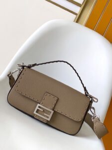 Baguette Medium.  Authentic quality luxury bag crafted in genuine leather comes with authenticity card, dust bag and gift bag. A Legacy in Every Stitch. An icon, reimagined with artisanal mastery—the *ENDI Medium Baguette is a tribute to heritage and timeless design. Crafted in rich cappuccino Cuoio Romano leather, this piece features 612 hand-sewn tone-on-tone macro topstitches, showcasing the legendary Selleria craftsmanship passed down since 1925. Its structured silhouette is elevated by the signature FF clasp, while the soft calfskin interior, complete with a zip pocket, keeps essentials elegantly organized. Finished with a silver Selleria plaque and palladium-finish hardware, every detail speaks of quiet luxury. Versatility meets sophistication with a detachable handle and shoulder strap, allowing it to be carried by hand, worn on the shoulder, or styled cross-body. A true icon—crafted by hand, designed to last a lifetime.