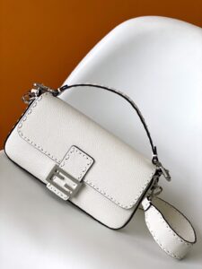 Baguette Medium.  Authentic quality luxury bag crafted in genuine leather comes with authenticity card, dust bag and gift bag. A Legacy in Every Stitch. An icon, reimagined with artisanal mastery—the *ENDI Medium Baguette is a tribute to heritage and timeless design. Crafted in rich cappuccino Cuoio Romano leather, this piece features 612 hand-sewn tone-on-tone macro topstitches, showcasing the legendary Selleria craftsmanship passed down since 1925. Its structured silhouette is elevated by the signature FF clasp, while the soft calfskin interior, complete with a zip pocket, keeps essentials elegantly organized. Finished with a silver Selleria plaque and palladium-finish hardware, every detail speaks of quiet luxury. Versatility meets sophistication with a detachable handle and shoulder strap, allowing it to be carried by hand, worn on the shoulder, or styled cross-body. A true icon—crafted by hand, designed to last a lifetime.