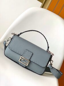 Baguette Medium.  Authentic quality luxury bag crafted in genuine leather comes with authenticity card, dust bag and gift bag. A Legacy in Every Stitch. An icon, reimagined with artisanal mastery—the *ENDI Medium Baguette is a tribute to heritage and timeless design. Crafted in rich cappuccino Cuoio Romano leather, this piece features 612 hand-sewn tone-on-tone macro topstitches, showcasing the legendary Selleria craftsmanship passed down since 1925. Its structured silhouette is elevated by the signature FF clasp, while the soft calfskin interior, complete with a zip pocket, keeps essentials elegantly organized. Finished with a silver Selleria plaque and palladium-finish hardware, every detail speaks of quiet luxury. Versatility meets sophistication with a detachable handle and shoulder strap, allowing it to be carried by hand, worn on the shoulder, or styled cross-body. A true icon—crafted by hand, designed to last a lifetime.