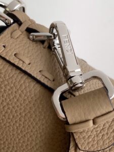 Baguette Medium.  Authentic quality luxury bag crafted in genuine leather comes with authenticity card, dust bag and gift bag. A Legacy in Every Stitch. An icon, reimagined with artisanal mastery—the *ENDI Medium Baguette is a tribute to heritage and timeless design. Crafted in rich cappuccino Cuoio Romano leather, this piece features 612 hand-sewn tone-on-tone macro topstitches, showcasing the legendary Selleria craftsmanship passed down since 1925. Its structured silhouette is elevated by the signature FF clasp, while the soft calfskin interior, complete with a zip pocket, keeps essentials elegantly organized. Finished with a silver Selleria plaque and palladium-finish hardware, every detail speaks of quiet luxury. Versatility meets sophistication with a detachable handle and shoulder strap, allowing it to be carried by hand, worn on the shoulder, or styled cross-body. A true icon—crafted by hand, designed to last a lifetime.