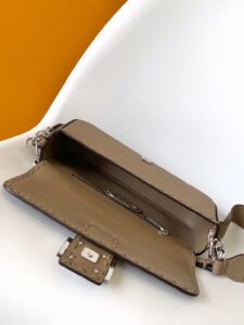 Baguette Medium.  Authentic quality luxury bag crafted in genuine leather comes with authenticity card, dust bag and gift bag. A Legacy in Every Stitch. An icon, reimagined with artisanal mastery—the *ENDI Medium Baguette is a tribute to heritage and timeless design. Crafted in rich cappuccino Cuoio Romano leather, this piece features 612 hand-sewn tone-on-tone macro topstitches, showcasing the legendary Selleria craftsmanship passed down since 1925. Its structured silhouette is elevated by the signature FF clasp, while the soft calfskin interior, complete with a zip pocket, keeps essentials elegantly organized. Finished with a silver Selleria plaque and palladium-finish hardware, every detail speaks of quiet luxury. Versatility meets sophistication with a detachable handle and shoulder strap, allowing it to be carried by hand, worn on the shoulder, or styled cross-body. A true icon—crafted by hand, designed to last a lifetime.