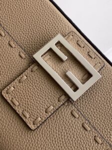 Baguette Medium.  Authentic quality luxury bag crafted in genuine leather comes with authenticity card, dust bag and gift bag. A Legacy in Every Stitch. An icon, reimagined with artisanal mastery—the *ENDI Medium Baguette is a tribute to heritage and timeless design. Crafted in rich cappuccino Cuoio Romano leather, this piece features 612 hand-sewn tone-on-tone macro topstitches, showcasing the legendary Selleria craftsmanship passed down since 1925. Its structured silhouette is elevated by the signature FF clasp, while the soft calfskin interior, complete with a zip pocket, keeps essentials elegantly organized. Finished with a silver Selleria plaque and palladium-finish hardware, every detail speaks of quiet luxury. Versatility meets sophistication with a detachable handle and shoulder strap, allowing it to be carried by hand, worn on the shoulder, or styled cross-body. A true icon—crafted by hand, designed to last a lifetime.