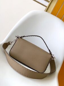 Baguette Medium.  Authentic quality luxury bag crafted in genuine leather comes with authenticity card, dust bag and gift bag. A Legacy in Every Stitch. An icon, reimagined with artisanal mastery—the *ENDI Medium Baguette is a tribute to heritage and timeless design. Crafted in rich cappuccino Cuoio Romano leather, this piece features 612 hand-sewn tone-on-tone macro topstitches, showcasing the legendary Selleria craftsmanship passed down since 1925. Its structured silhouette is elevated by the signature FF clasp, while the soft calfskin interior, complete with a zip pocket, keeps essentials elegantly organized. Finished with a silver Selleria plaque and palladium-finish hardware, every detail speaks of quiet luxury. Versatility meets sophistication with a detachable handle and shoulder strap, allowing it to be carried by hand, worn on the shoulder, or styled cross-body. A true icon—crafted by hand, designed to last a lifetime.