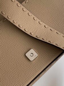 Baguette Medium.  Authentic quality luxury bag crafted in genuine leather comes with authenticity card, dust bag and gift bag. A Legacy in Every Stitch. An icon, reimagined with artisanal mastery—the *ENDI Medium Baguette is a tribute to heritage and timeless design. Crafted in rich cappuccino Cuoio Romano leather, this piece features 612 hand-sewn tone-on-tone macro topstitches, showcasing the legendary Selleria craftsmanship passed down since 1925. Its structured silhouette is elevated by the signature FF clasp, while the soft calfskin interior, complete with a zip pocket, keeps essentials elegantly organized. Finished with a silver Selleria plaque and palladium-finish hardware, every detail speaks of quiet luxury. Versatility meets sophistication with a detachable handle and shoulder strap, allowing it to be carried by hand, worn on the shoulder, or styled cross-body. A true icon—crafted by hand, designed to last a lifetime.