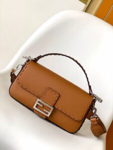Baguette Medium.  Authentic quality luxury bag crafted in genuine leather comes with authenticity card, dust bag and gift bag. A Legacy in Every Stitch. An icon, reimagined with artisanal mastery—the *ENDI Medium Baguette is a tribute to heritage and timeless design. Crafted in rich cappuccino Cuoio Romano leather, this piece features 612 hand-sewn tone-on-tone macro topstitches, showcasing the legendary Selleria craftsmanship passed down since 1925. Its structured silhouette is elevated by the signature FF clasp, while the soft calfskin interior, complete with a zip pocket, keeps essentials elegantly organized. Finished with a silver Selleria plaque and palladium-finish hardware, every detail speaks of quiet luxury. Versatility meets sophistication with a detachable handle and shoulder strap, allowing it to be carried by hand, worn on the shoulder, or styled cross-body. A true icon—crafted by hand, designed to last a lifetime.