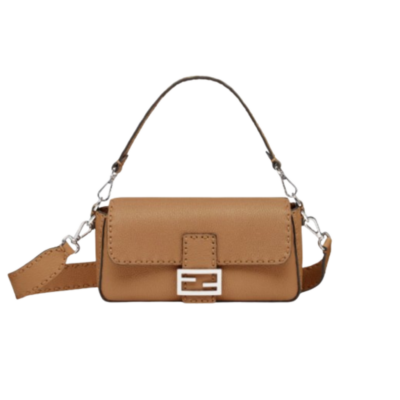 Baguette Medium. Authentic quality luxury bag crafted in genuine leather comes with authenticity card, dust bag and gift bag. A Legacy in Every Stitch. An icon, reimagined with artisanal mastery—the *ENDI Medium Baguette is a tribute to heritage and timeless design. Crafted in rich cappuccino Cuoio Romano leather, this piece features 612 hand-sewn tone-on-tone macro topstitches, showcasing the legendary Selleria craftsmanship passed down since 1925. Its structured silhouette is elevated by the signature FF clasp, while the soft calfskin interior, complete with a zip pocket, keeps essentials elegantly organized. Finished with a silver Selleria plaque and palladium-finish hardware, every detail speaks of quiet luxury. Versatility meets sophistication with a detachable handle and shoulder strap, allowing it to be carried by hand, worn on the shoulder, or styled cross-body. A true icon—crafted by hand, designed to last a lifetime.