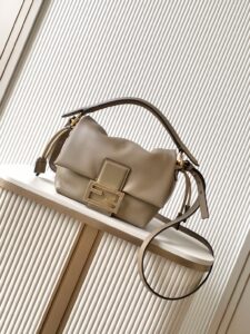Small Mamma Baguette. Authentic quality luxury bag crafted in genuine leather comes with authenticity card, dust bag and gift bag. A Soft Revival of an Icon. Born in the late ’90s as the effortlessly chic “big sister” to the original, the Mamma Baguette returns for Spring/Summer 2025 with a modern, deconstructed allure. Reimagined in dreamy nappa leather, it blends nostalgia with a fresh, fluid silhouette that feels both relaxed and refined. An oversized FF clasp, accented with a tonal leather insert, anchors the design with signature *ENDI attitude. Inside, a generously sized suede-lined compartment with a drawstring closure and ties offers both luxury and practicality. Finished with gold-tone hardware and complete with detachable handle and shoulder strap, it transitions seamlessly from hand-held elegance to crossbody ease. Soft, iconic, and undeniably modern—the Mamma Baguette is back, and better than ever.