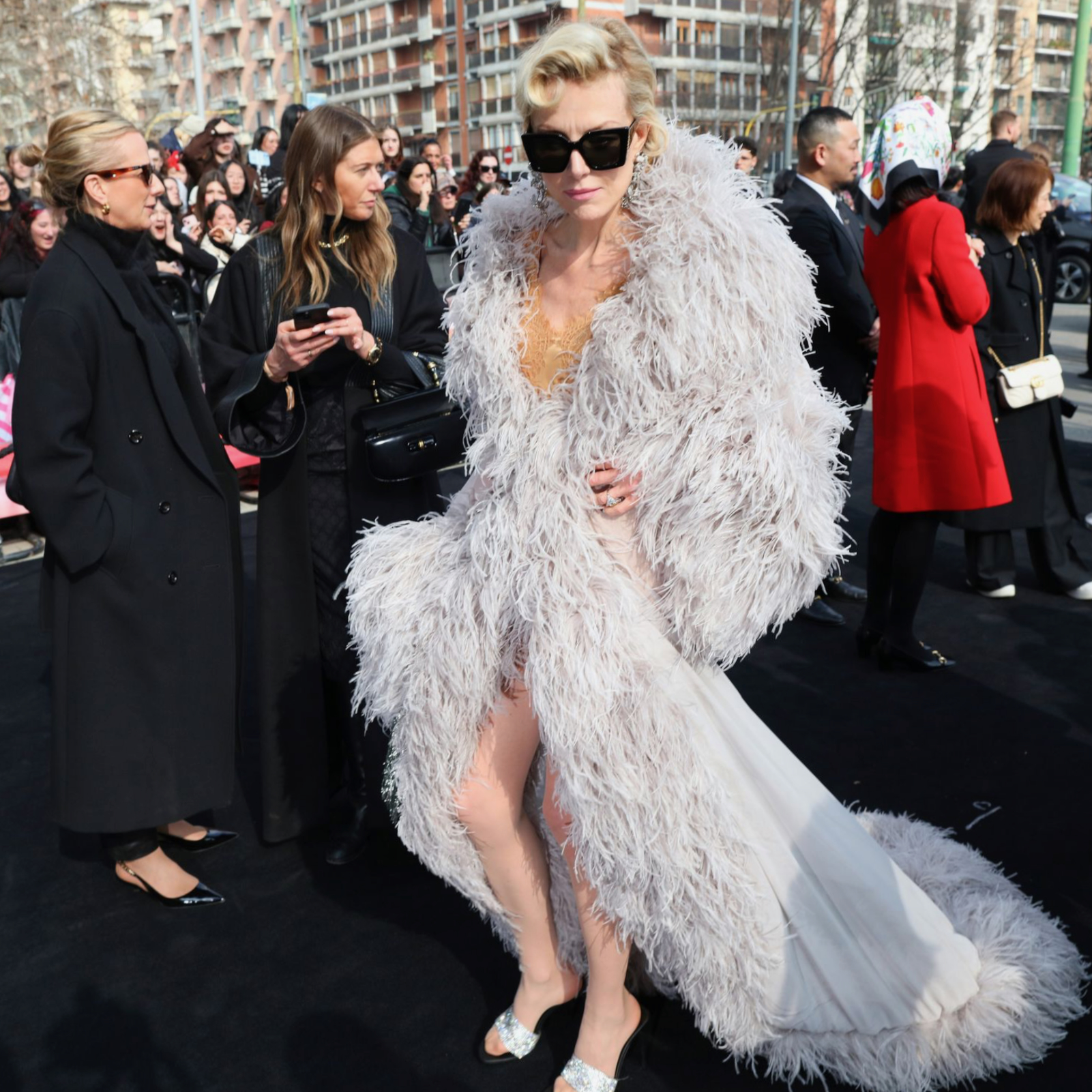Paris Fashion Week Street Style in Feathered Couture Coat Luxury street style at Paris Fashion Week featuring a dramatic feathered coat and couture-inspired look
