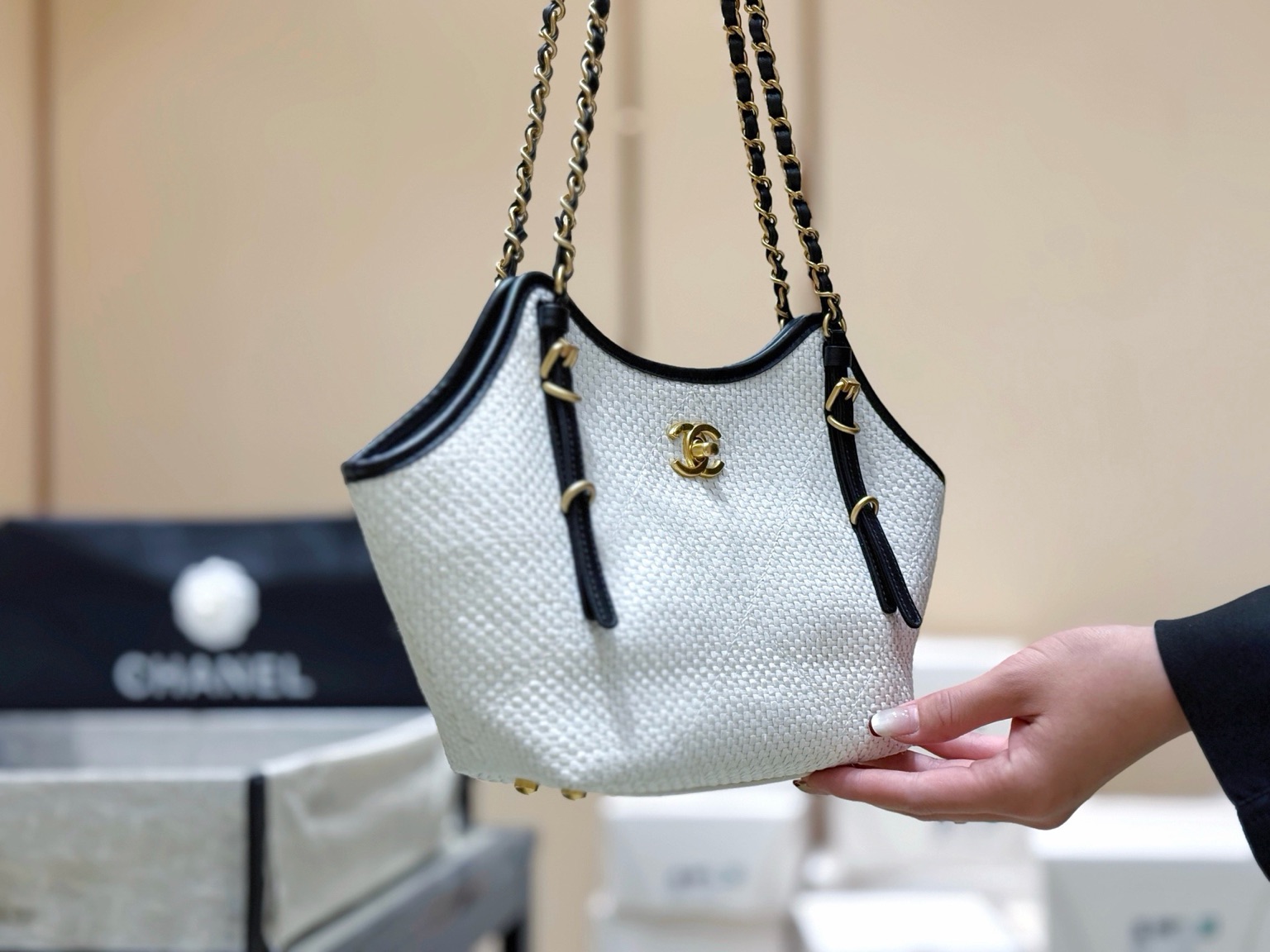 Raffia Braided Small Shopping Tote 9 Raffia Braided Small Shopping Tote. Authentic quality luxury bag crafted in genuine leather comes with authenticity card, dust bag and gift bag. Effortless Summer Sophistication. The *ANEL Small Tote brings a fresh, summery spirit to timeless *ANEL elegance. Crafted from beautifully braided raffia and refined calfskin, its sophisticated black-and-white palette creates an effortlessly chic look. Natural raffia texture adds relaxed seasonal charm, while smooth calfskin details bring structure and a luxurious finish. Luminous gold-tone hardware completes the design with a subtle touch of glamour. Light, versatile, and undeniably elegant, this tote is made for everyday moments when effortless style matters. A modern summer classic with unmistakable *ANEL allure.