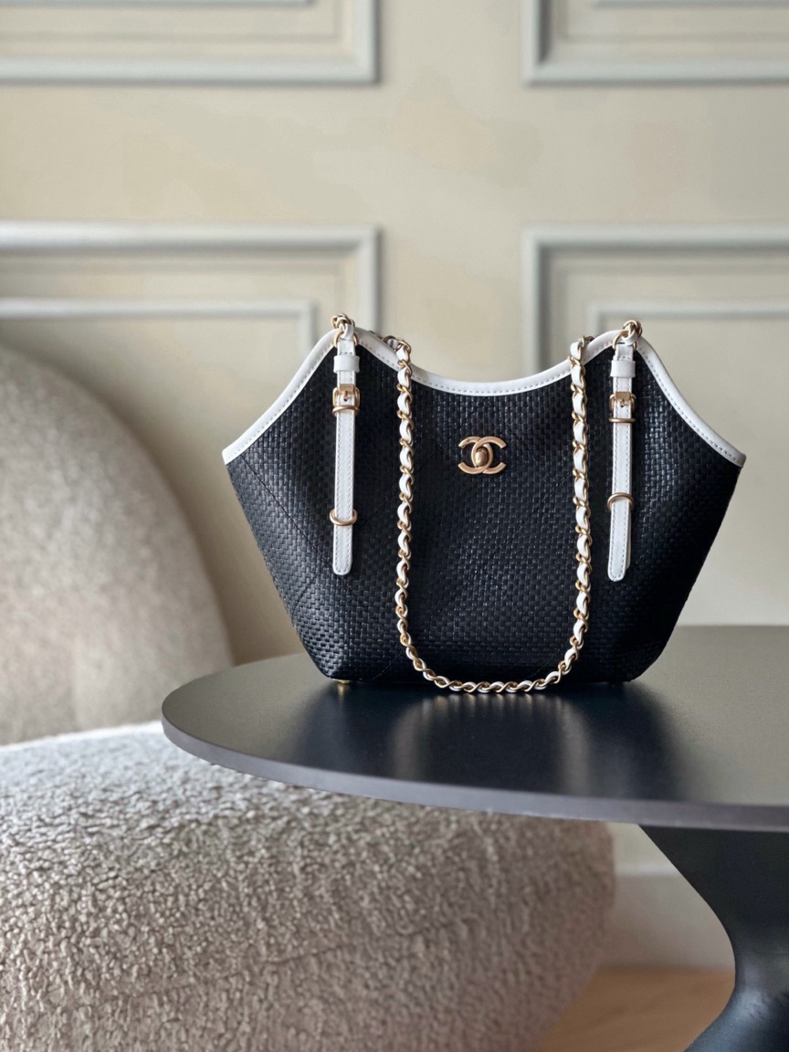 Raffia Braided Small Shopping Tote 2 Raffia Braided Small Shopping Tote. Authentic quality luxury bag crafted in genuine leather comes with authenticity card, dust bag and gift bag. Effortless Summer Sophistication. The *ANEL Small Tote brings a fresh, summery spirit to timeless *ANEL elegance. Crafted from beautifully braided raffia and refined calfskin, its sophisticated black-and-white palette creates an effortlessly chic look. Natural raffia texture adds relaxed seasonal charm, while smooth calfskin details bring structure and a luxurious finish. Luminous gold-tone hardware completes the design with a subtle touch of glamour. Light, versatile, and undeniably elegant, this tote is made for everyday moments when effortless style matters. A modern summer classic with unmistakable *ANEL allure.