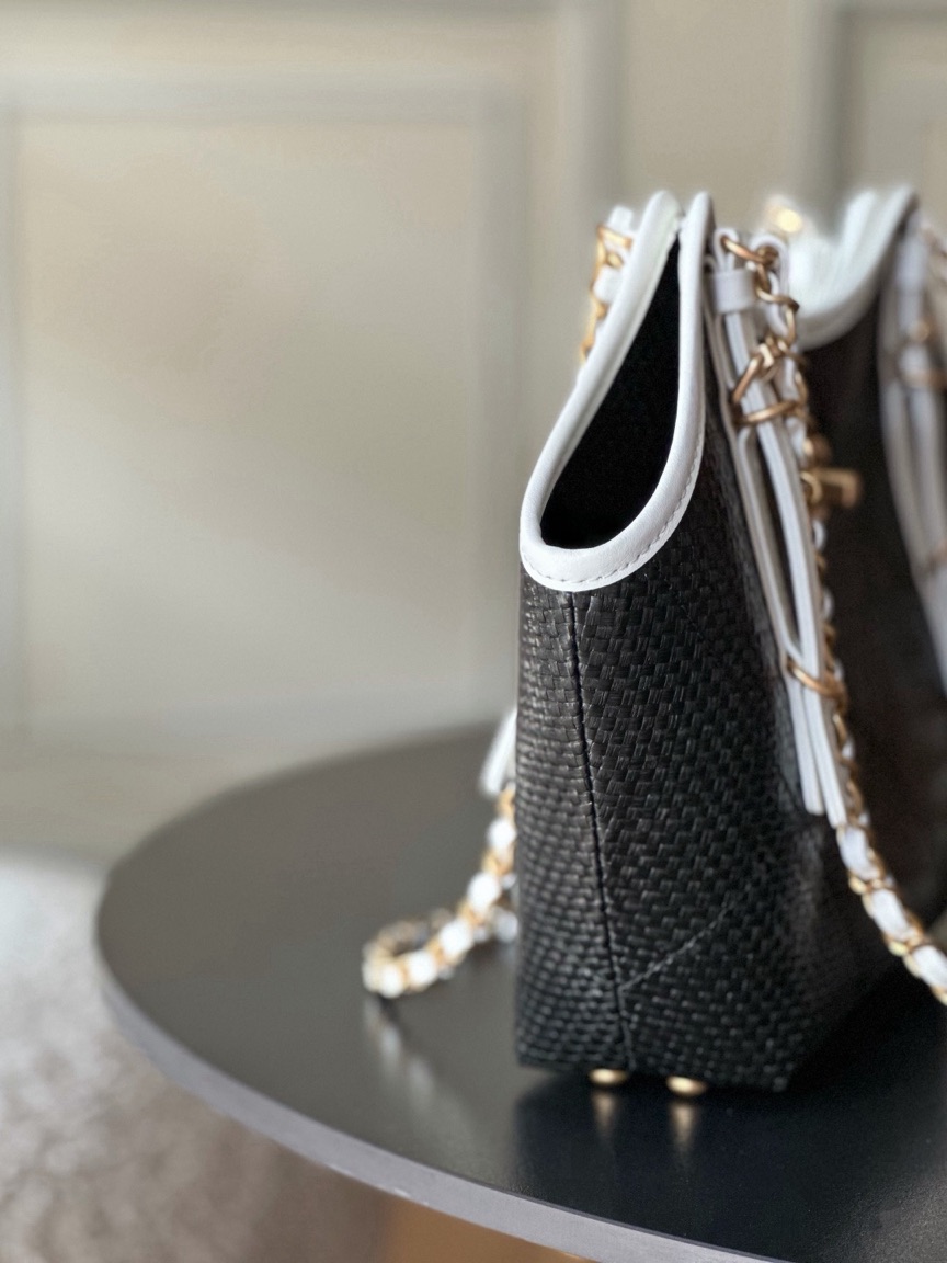 Raffia Braided Small Shopping Tote 7 Raffia Braided Small Shopping Tote. Authentic quality luxury bag crafted in genuine leather comes with authenticity card, dust bag and gift bag. Effortless Summer Sophistication. The *ANEL Small Tote brings a fresh, summery spirit to timeless *ANEL elegance. Crafted from beautifully braided raffia and refined calfskin, its sophisticated black-and-white palette creates an effortlessly chic look. Natural raffia texture adds relaxed seasonal charm, while smooth calfskin details bring structure and a luxurious finish. Luminous gold-tone hardware completes the design with a subtle touch of glamour. Light, versatile, and undeniably elegant, this tote is made for everyday moments when effortless style matters. A modern summer classic with unmistakable *ANEL allure.